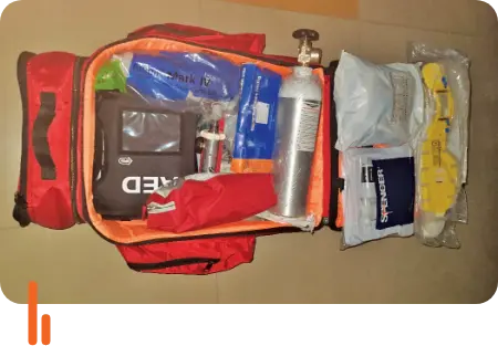 A first-responder medical kit containing various emergency supplies, including an oxygen cylinder, bandages, and other medical equipment, donated to a railway station in Mysuru, Karnataka