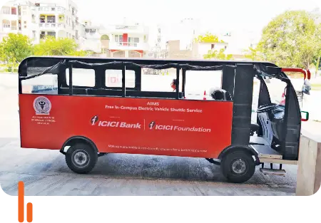 An electric vehicle (EV) donated by ICICI Bank and ICICI Foundation for free in-campus shuttle service at AIIMS New Delhi, parked and ready for use.