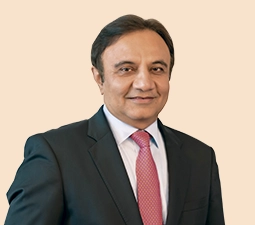 Portrait of Sandeep Bakhshi, Managing Director & CEO of ICICI Bank, wearing a black suit with a pink tie, representing his leadership role within the bank.